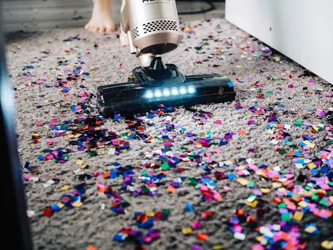 Vacuuming a carpeted floor