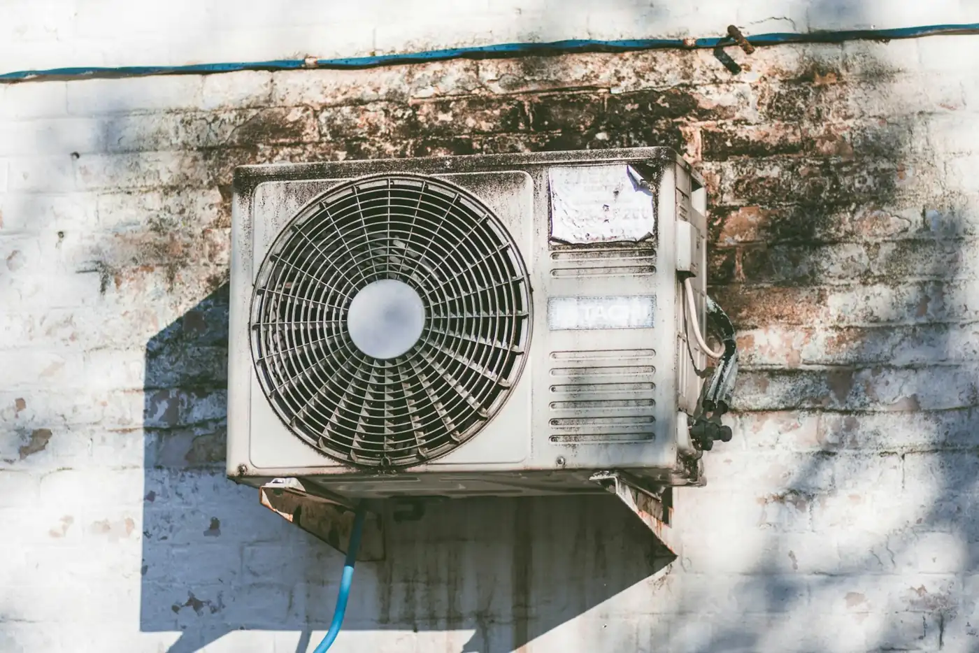 Outdoor HVAC air-conditioning condenser unit beside a home